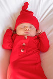 Newborn baby with red baby gown for Christmas baby's first Christmas picture